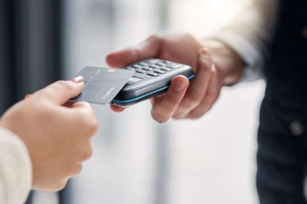 Debit card, pos payment and hands of people, woman or courier delivery man with retail sale machine.